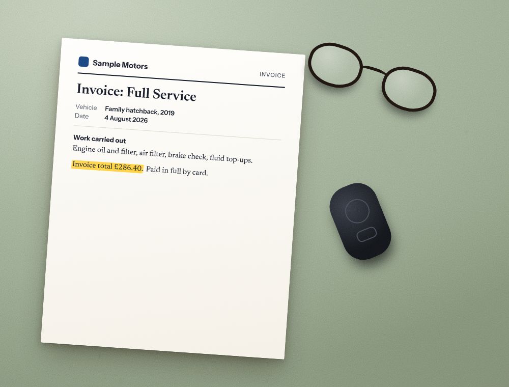 A car service invoice with the total highlighted, next to a car key fob and reading glasses.